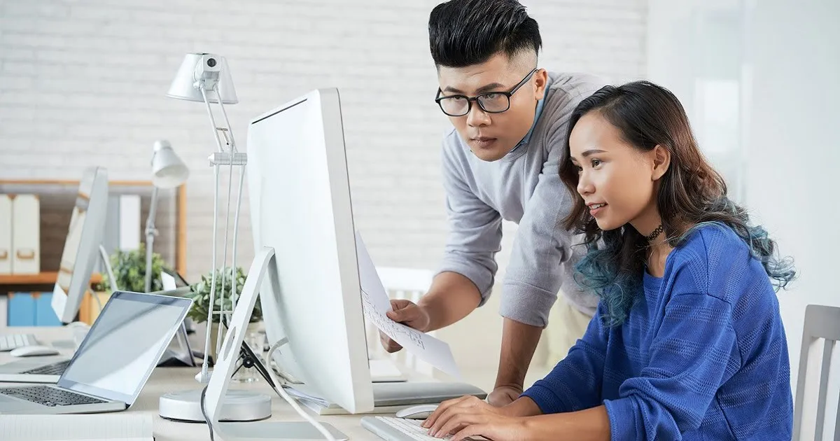 People collaborating at a computer